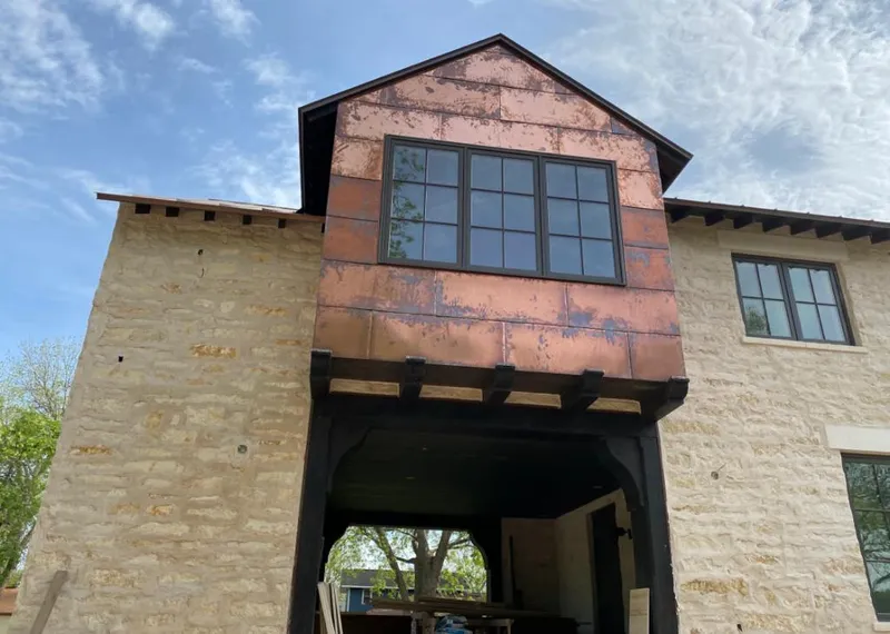 Copper metal panel facade on a stone building for Skylight Installation in Detroit Lakes