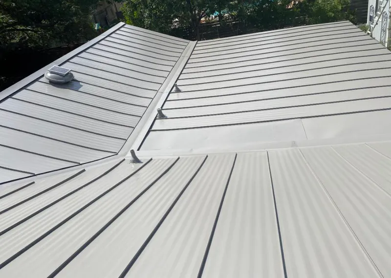 Solar attic fan installed on a metal roof for Roof Ventilation in Detroit Lakes